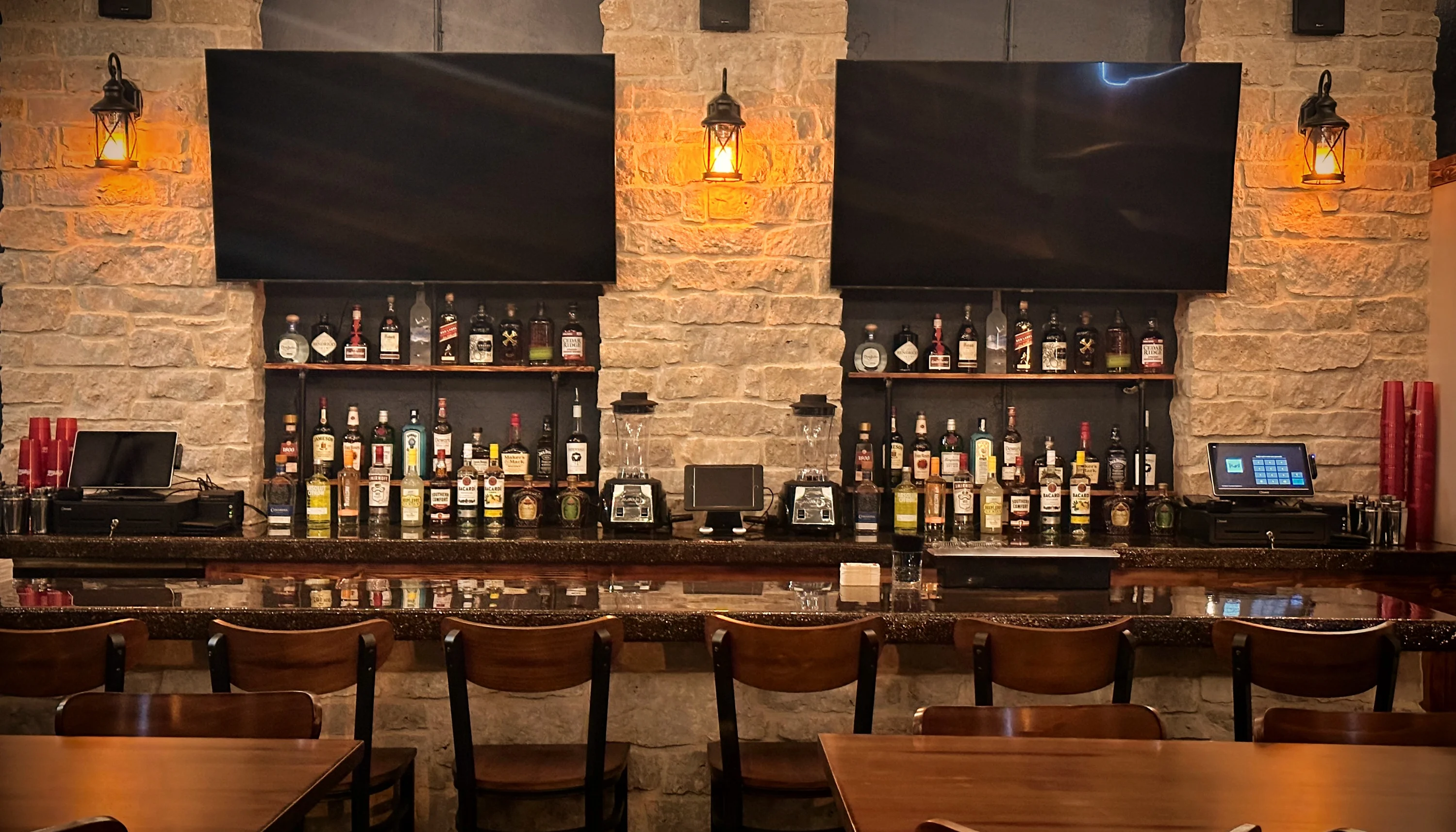 Stylish bar counter with a variety of spirits and warm lighting