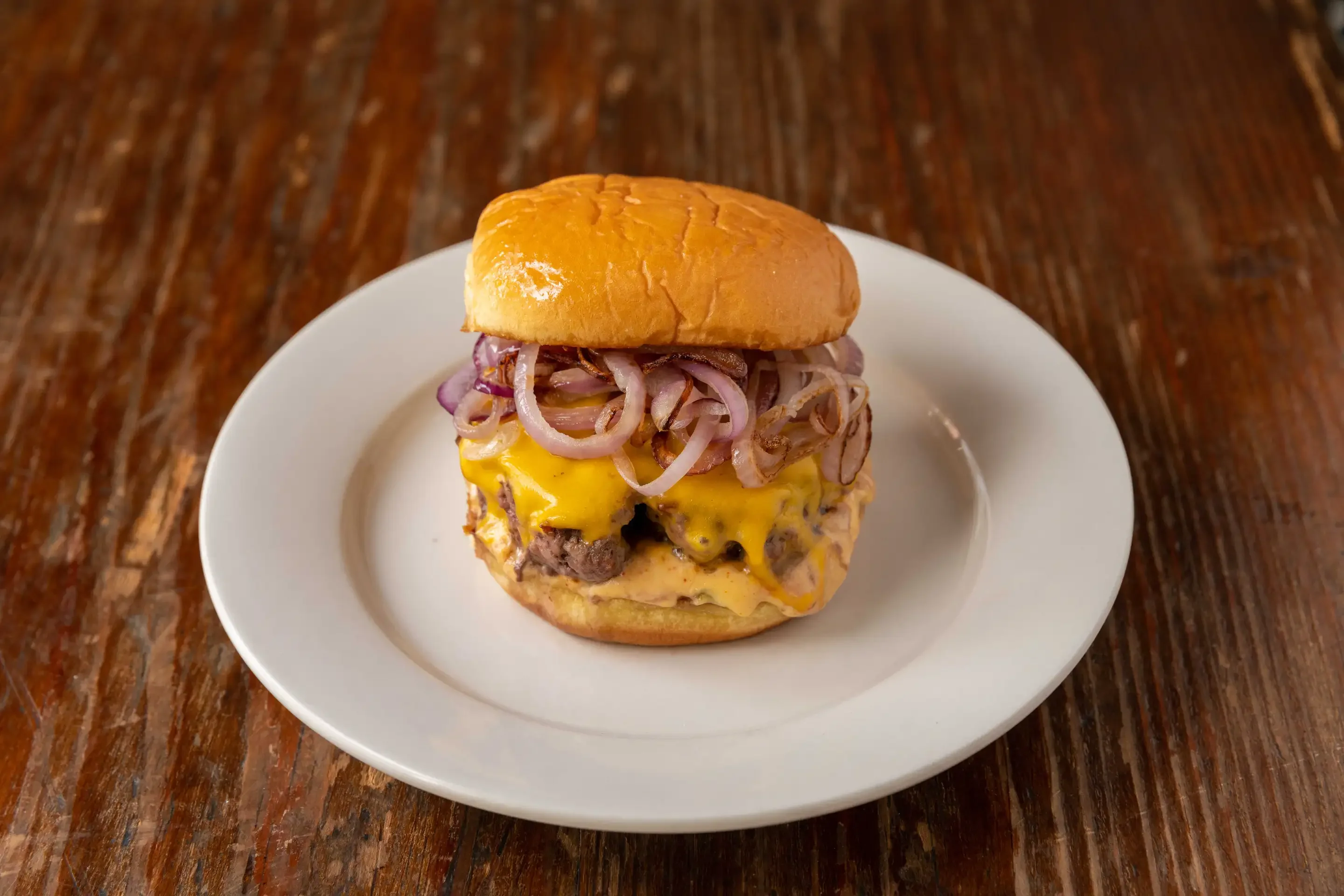 Juicy cheeseburger with grilled onions on a toasted bun