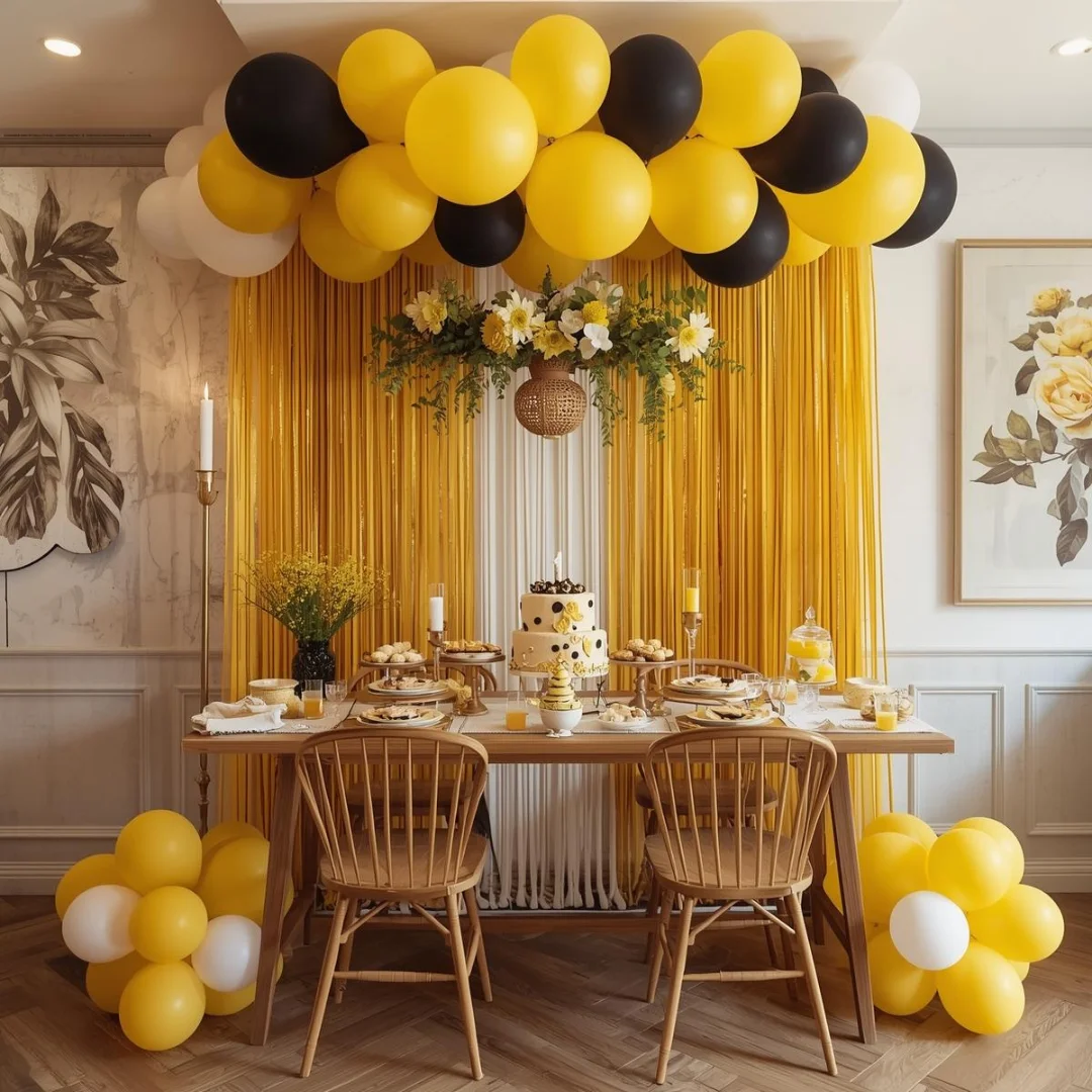Festive birthday table decor with yellow and black balloons