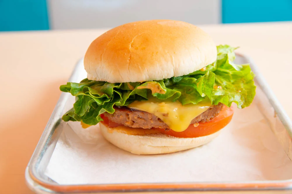 Delicious gourmet burger with fresh toppings on a wooden table