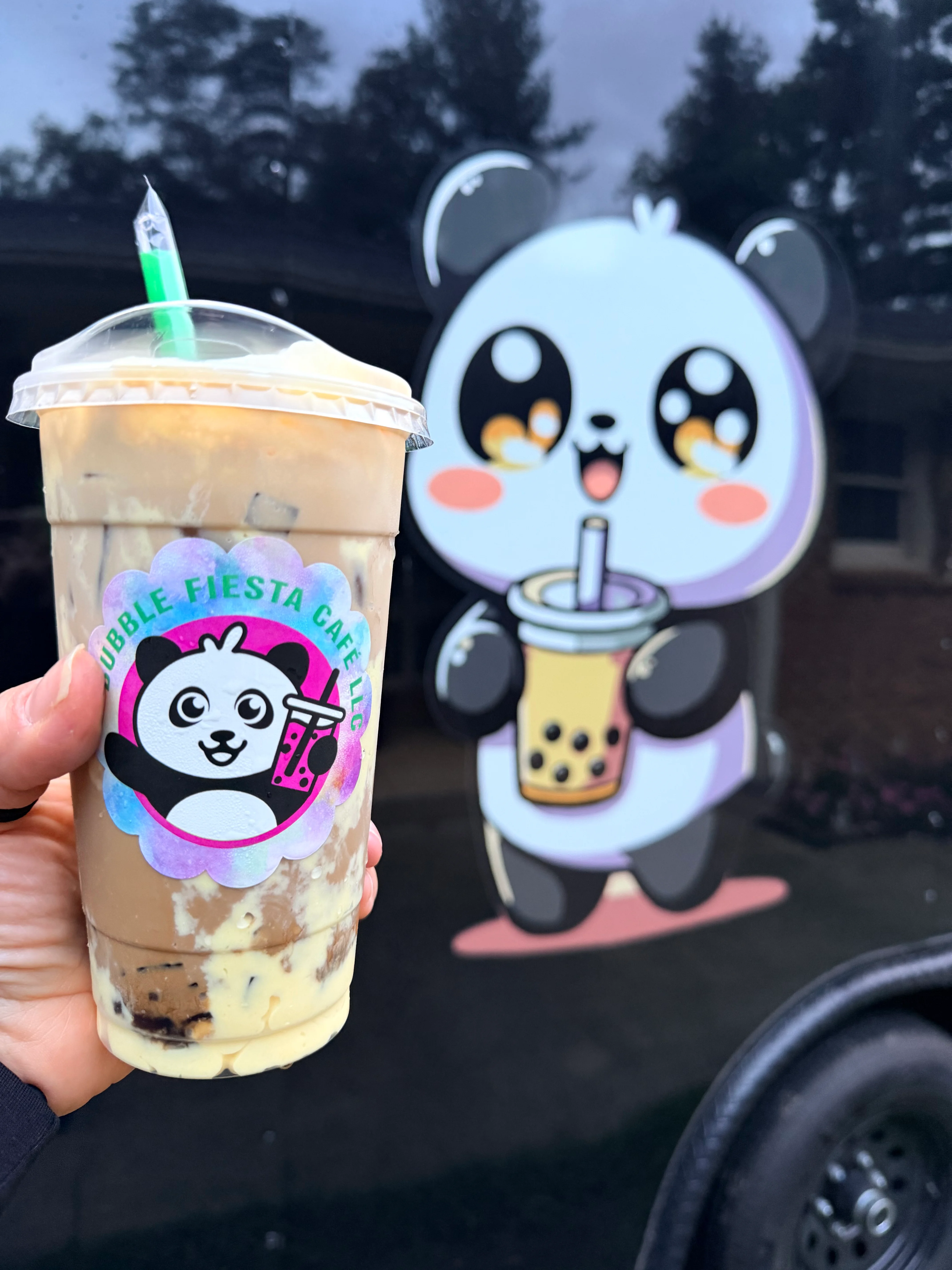 Iced bubble tea with a panda logo in the background