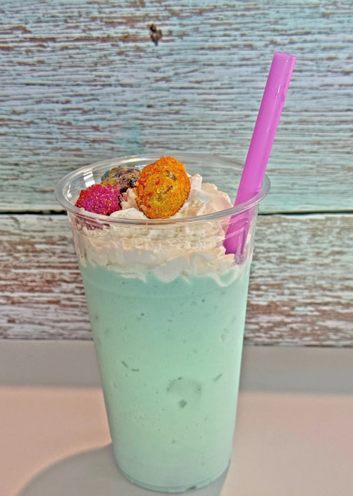Colorful cotton candy dessert with vibrant toppings and a whimsical presentation.