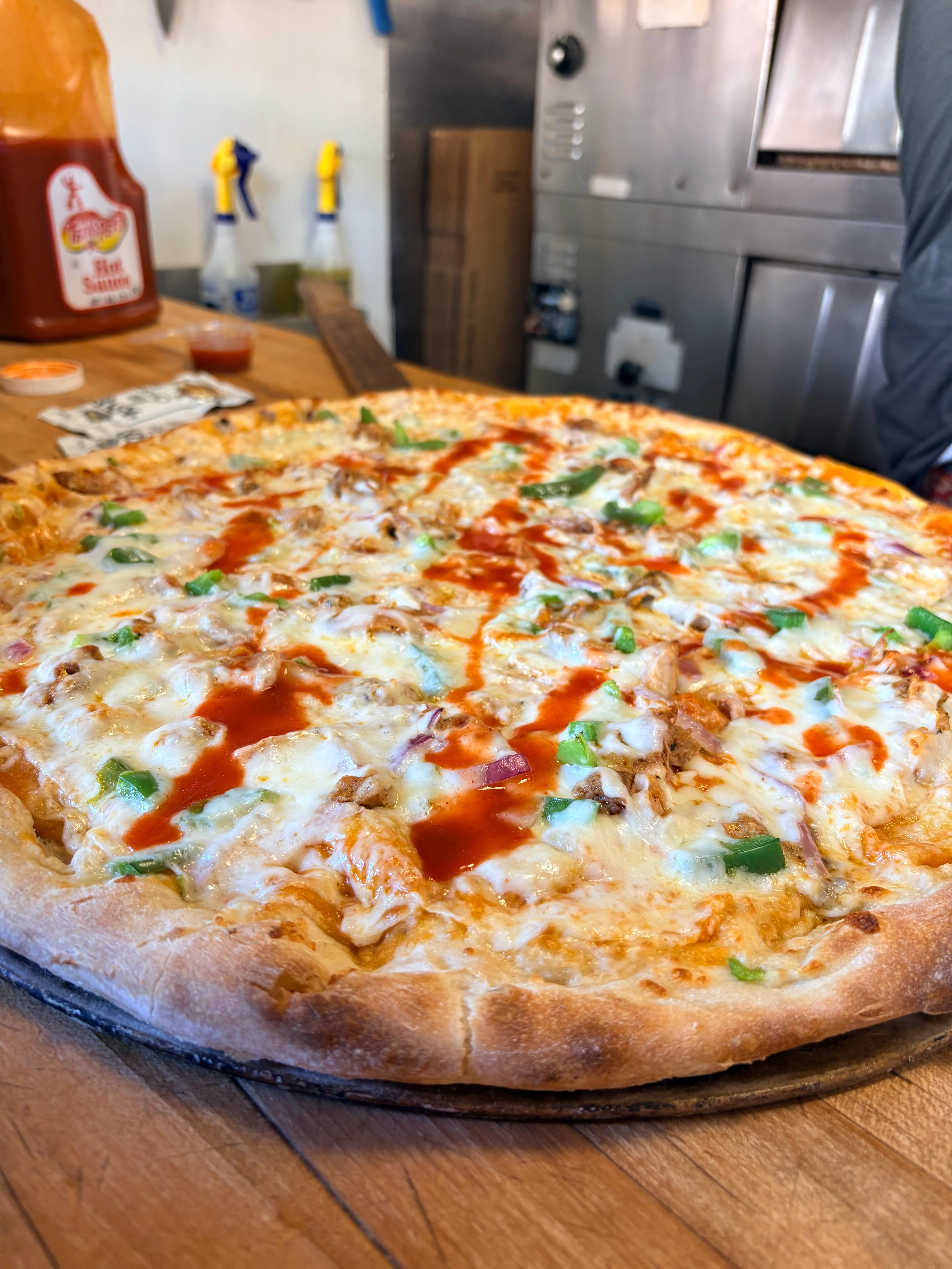 BBQ chicken pizza with cheese and green peppers