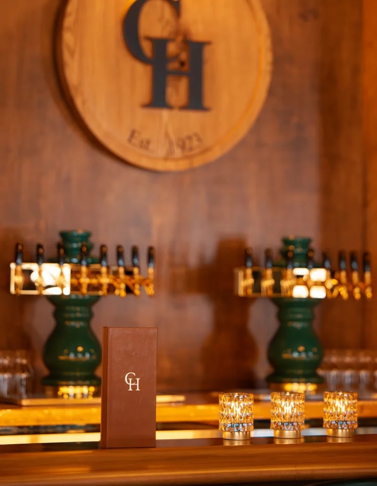 Elegant bar interior with a wooden logo and stylish drink menu