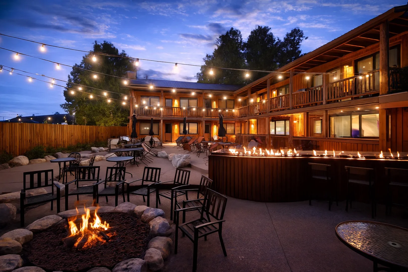 Cozy outdoor seating area with fire pit and string lights
