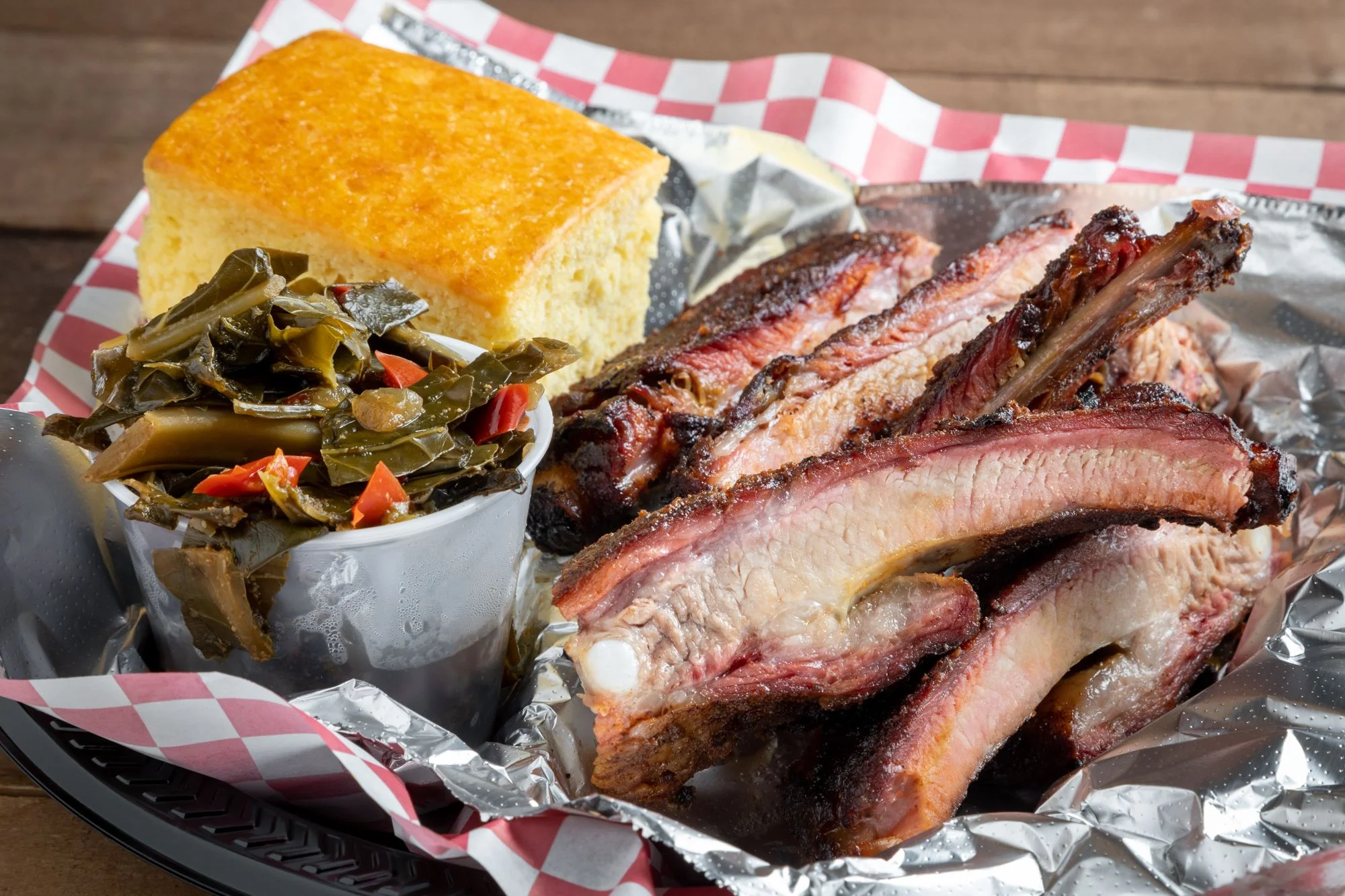 Southern barbecue ribs with cornbread and collard greens