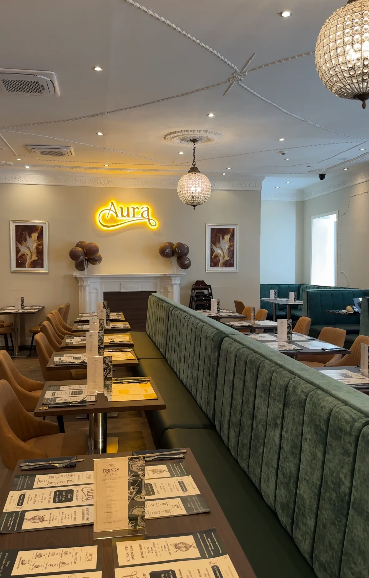 Interior of Aura restaurant with seating and decorative lighting.