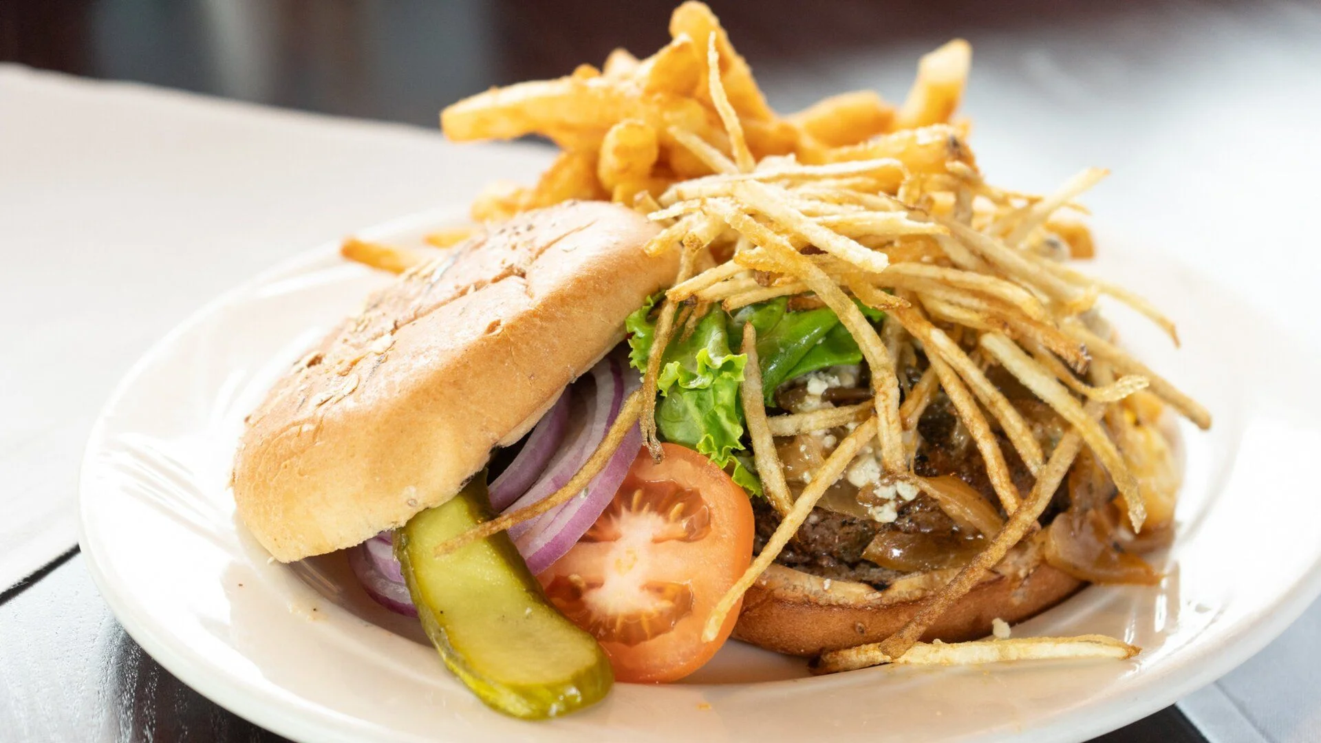 Gourmet burger with crispy fries and fresh toppings