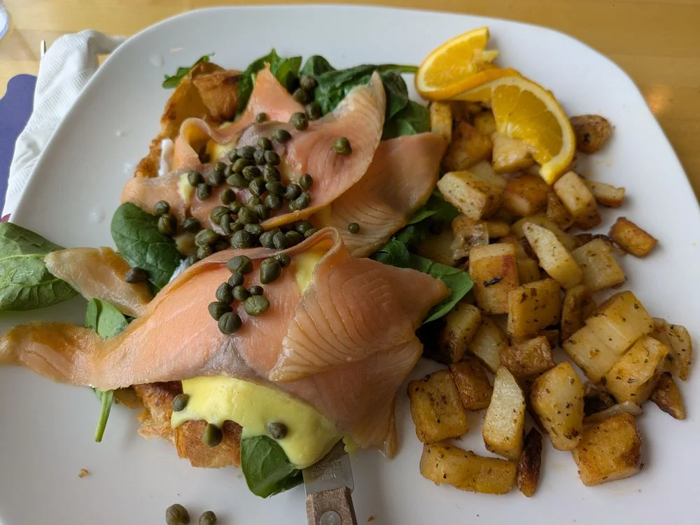 Delicious salmon benedict served on a plate with garnishes.