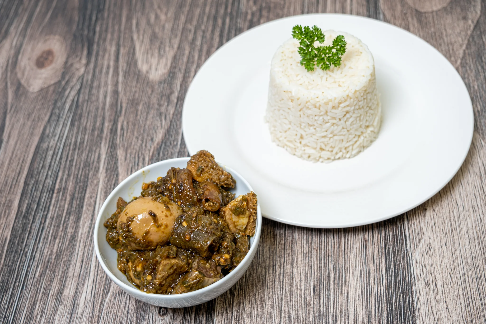 Nigerian egusi soup served with rice