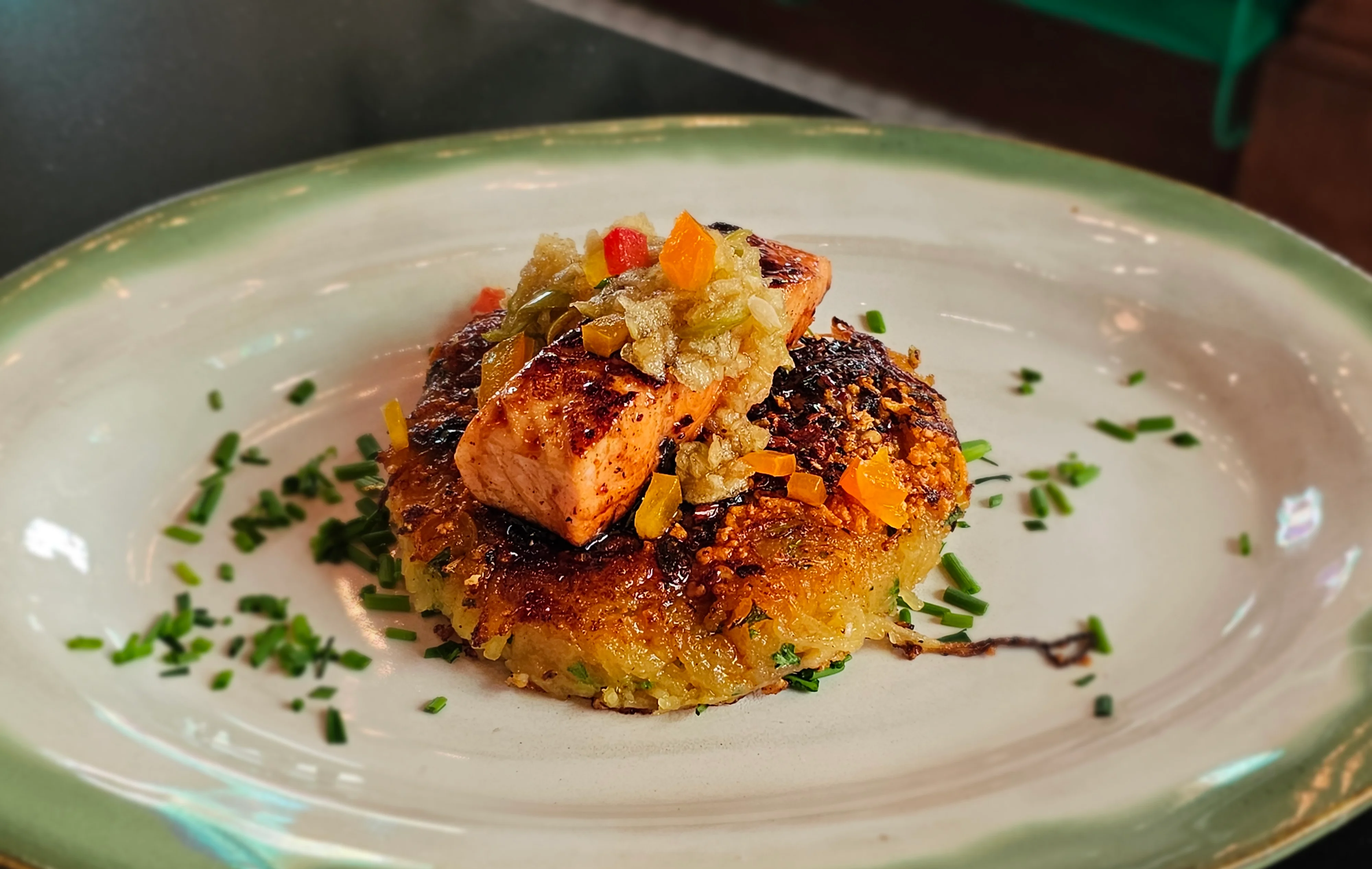Grilled salmon on a crispy potato cake with salsa verde