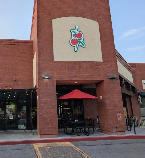 Brick restaurant exterior with patio seating and string lights