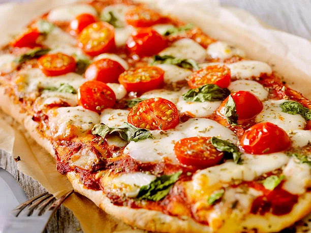 Fresh Margherita pizza with tomatoes and basil