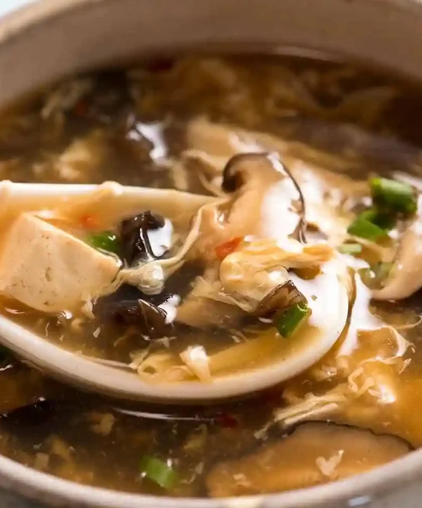 Chinese hot and sour soup in a bowl with spoon