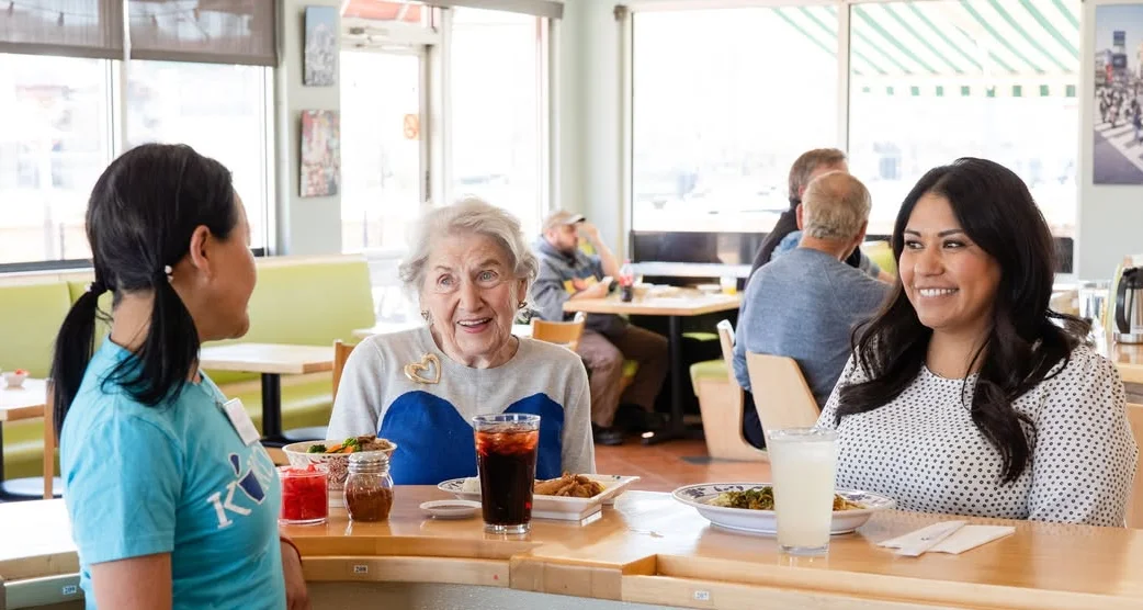 Warm restaurant atmosphere with diners enjoying meals and drinks