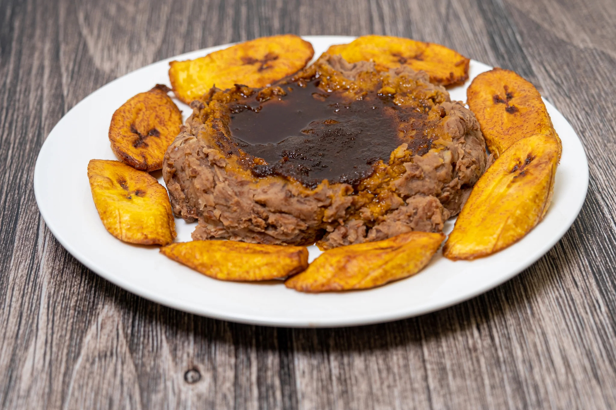 Dominican mofongo with fried plantains on a white plate