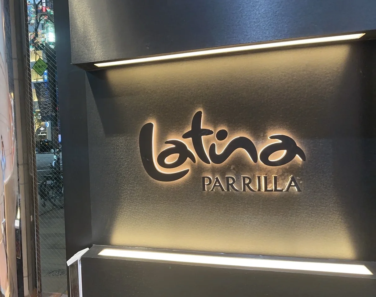 Signage of Latina Parrilla restaurant in an urban setting