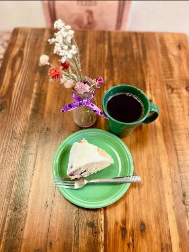 Slice of cake with coffee in a cozy café setting