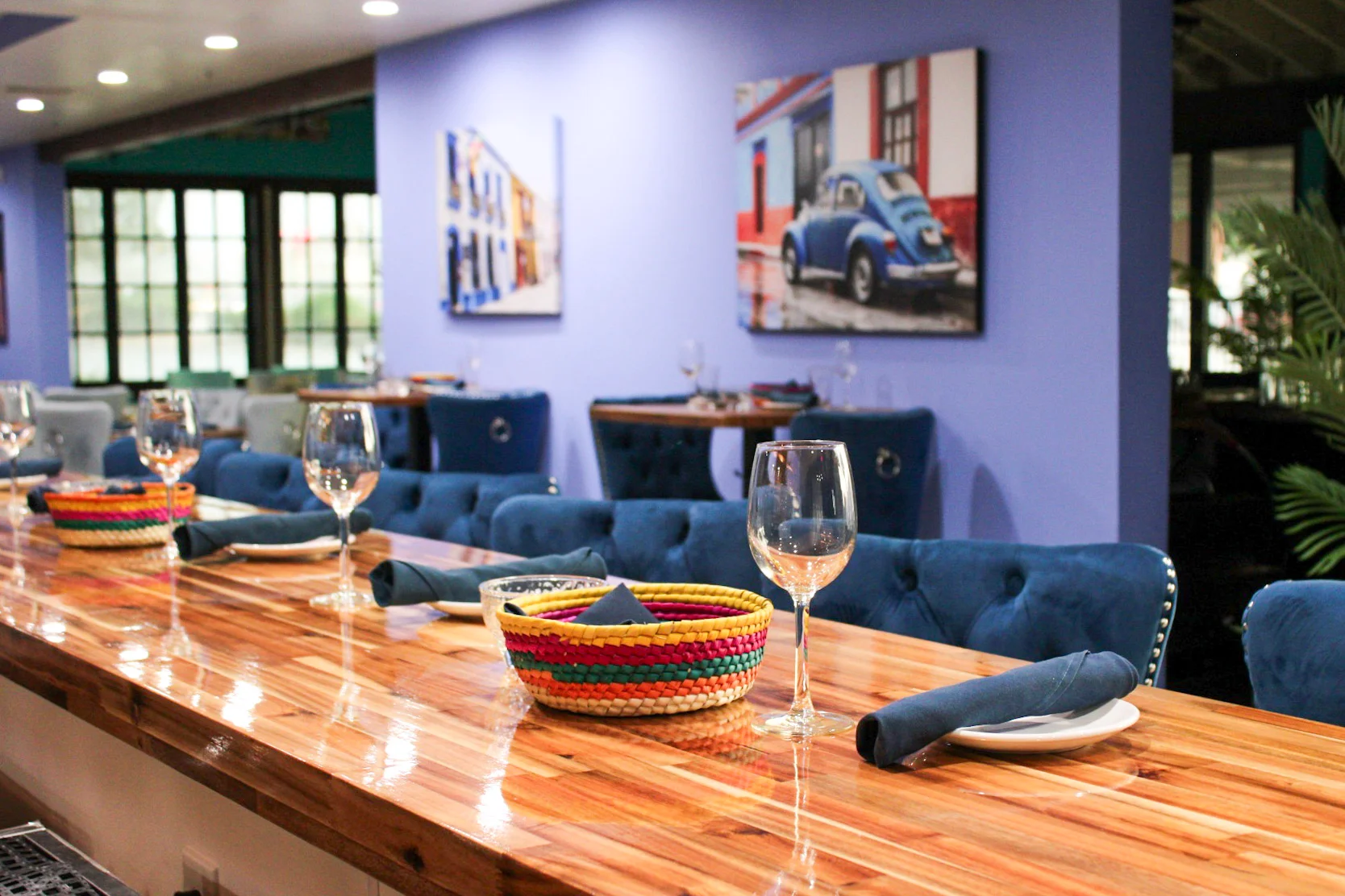 Stylish restaurant interior with blue seating and wooden bar