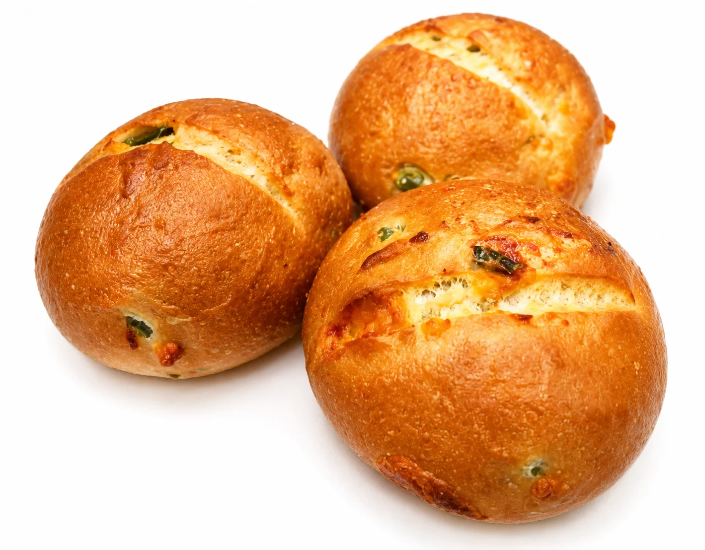 Three freshly baked round bread rolls with a golden crust.