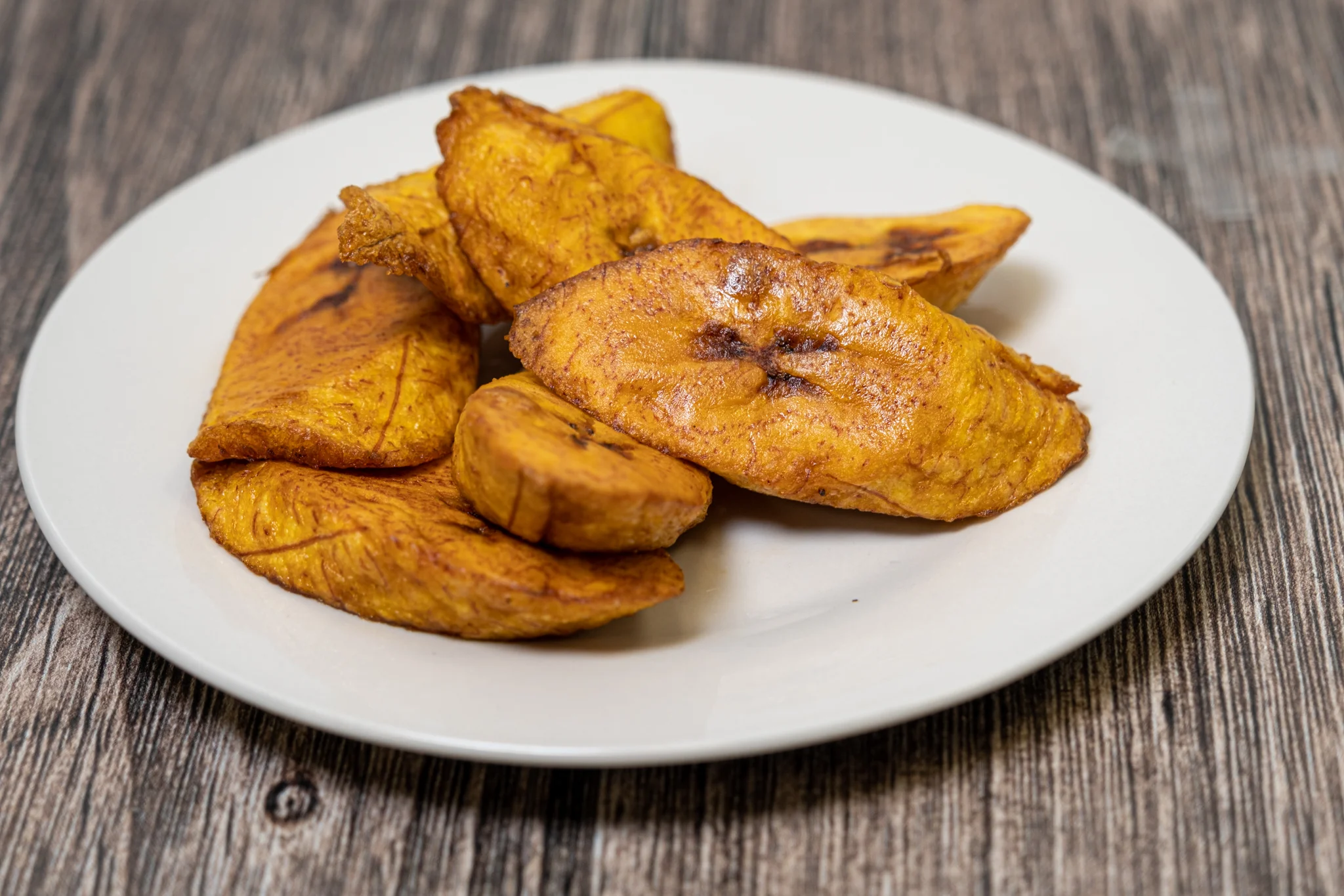 Fried plantains served on a white plate
