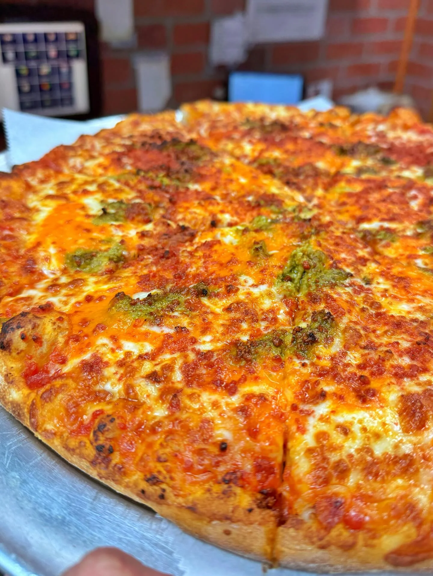 A freshly baked pizza with a crispy crust, topped with a rich tomato sauce and a blend of melted cheeses with herbs.