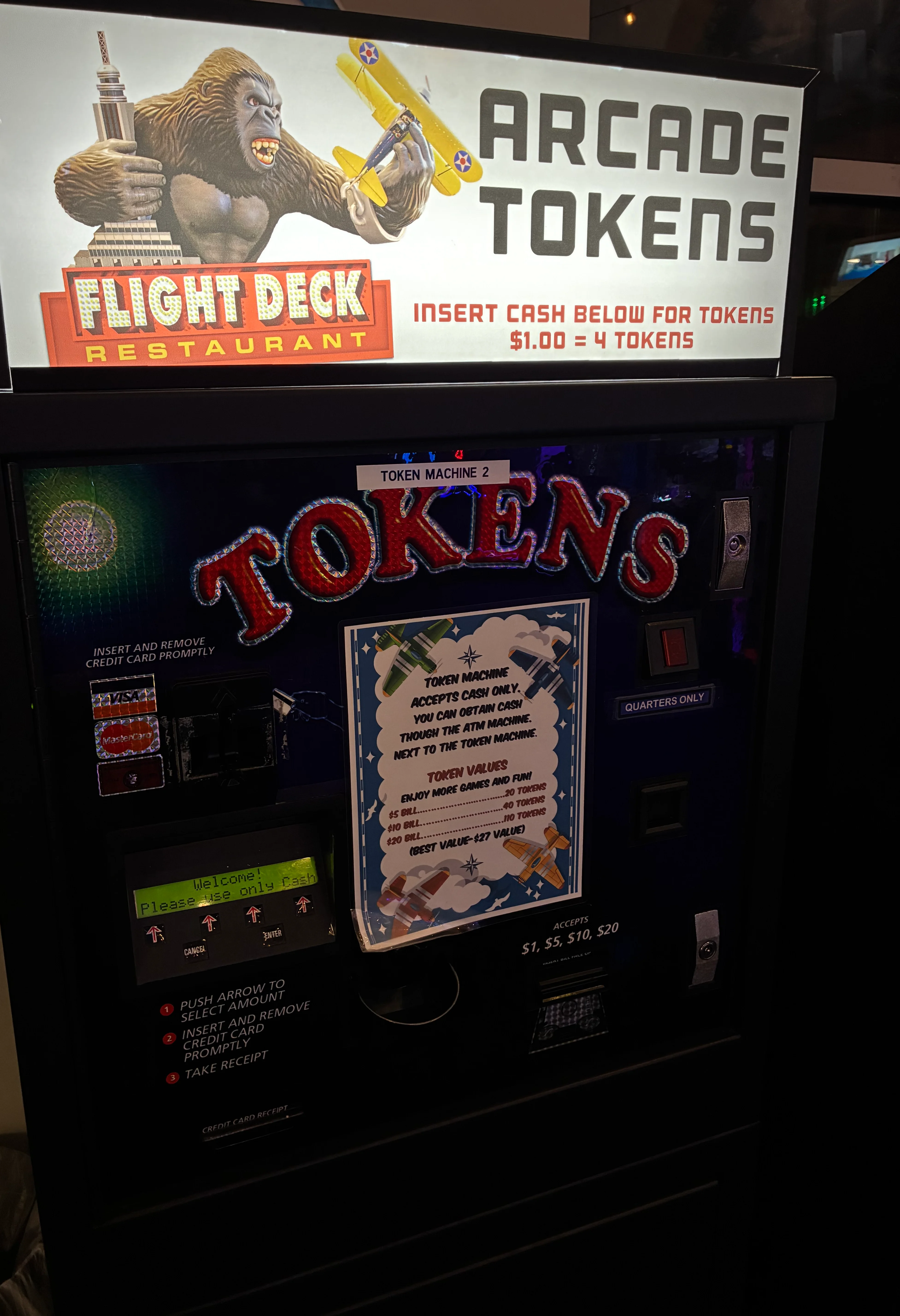 Tilted close-up of restaurant arcade machine with colorful graphic signage