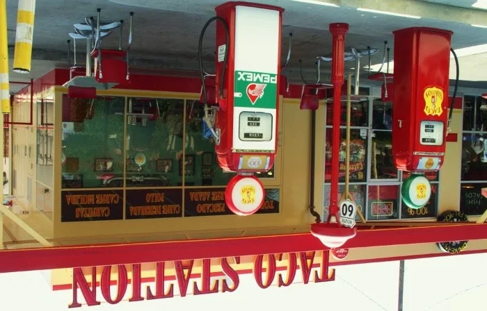 Taco Station restaurant exterior with vintage gas pumps