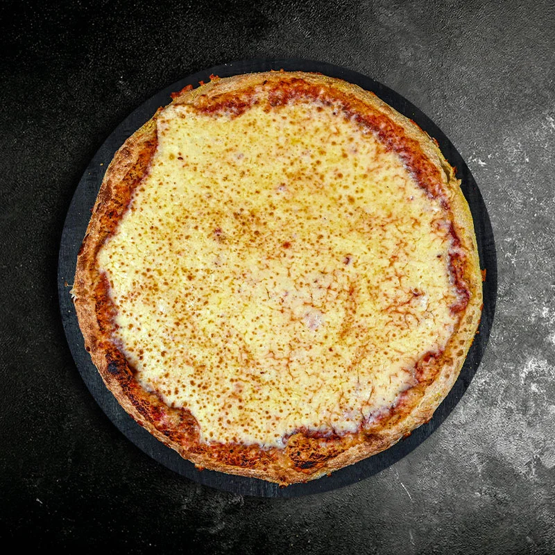 Classic cheese pizza on a black stone serving board