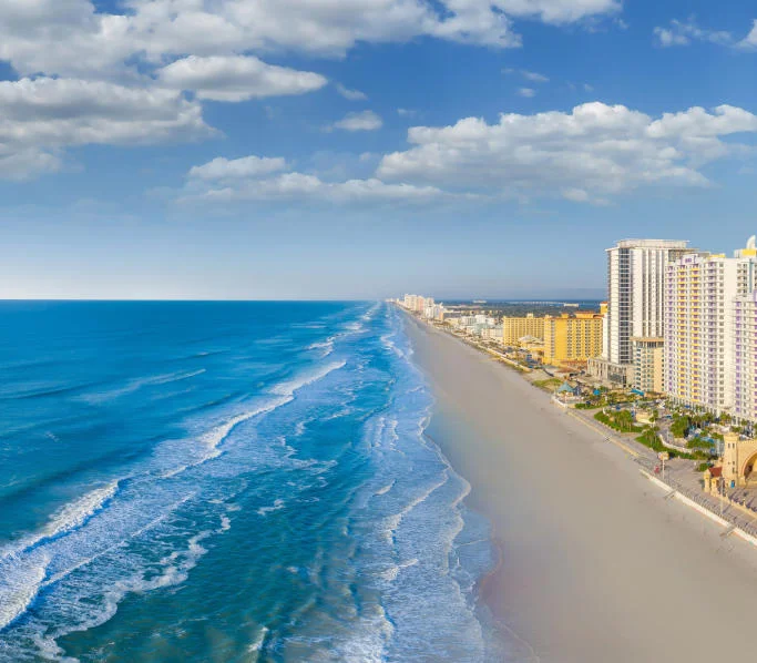 Scenic beach view with ocean and skyline under a blue sky
