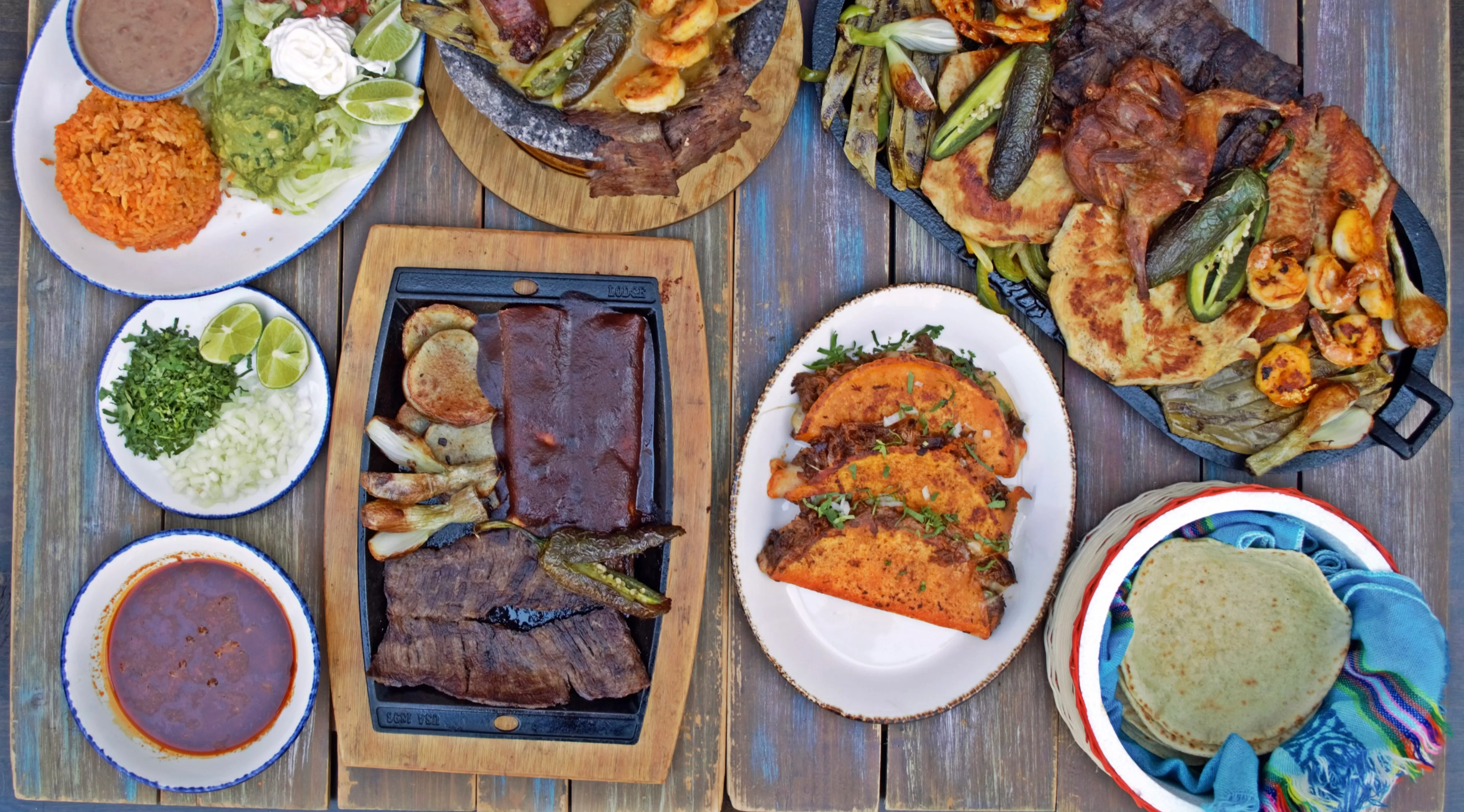 Delicious gourmet burger with fresh ingredients on a wooden table.