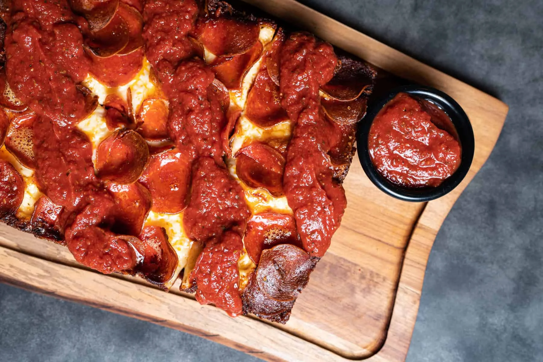 Delicious gourmet burger with fresh toppings on a wooden table