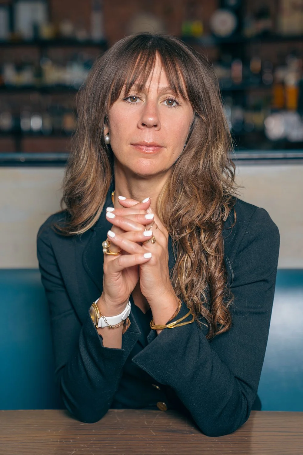 Professional woman in a restaurant setting with a thoughtful expression