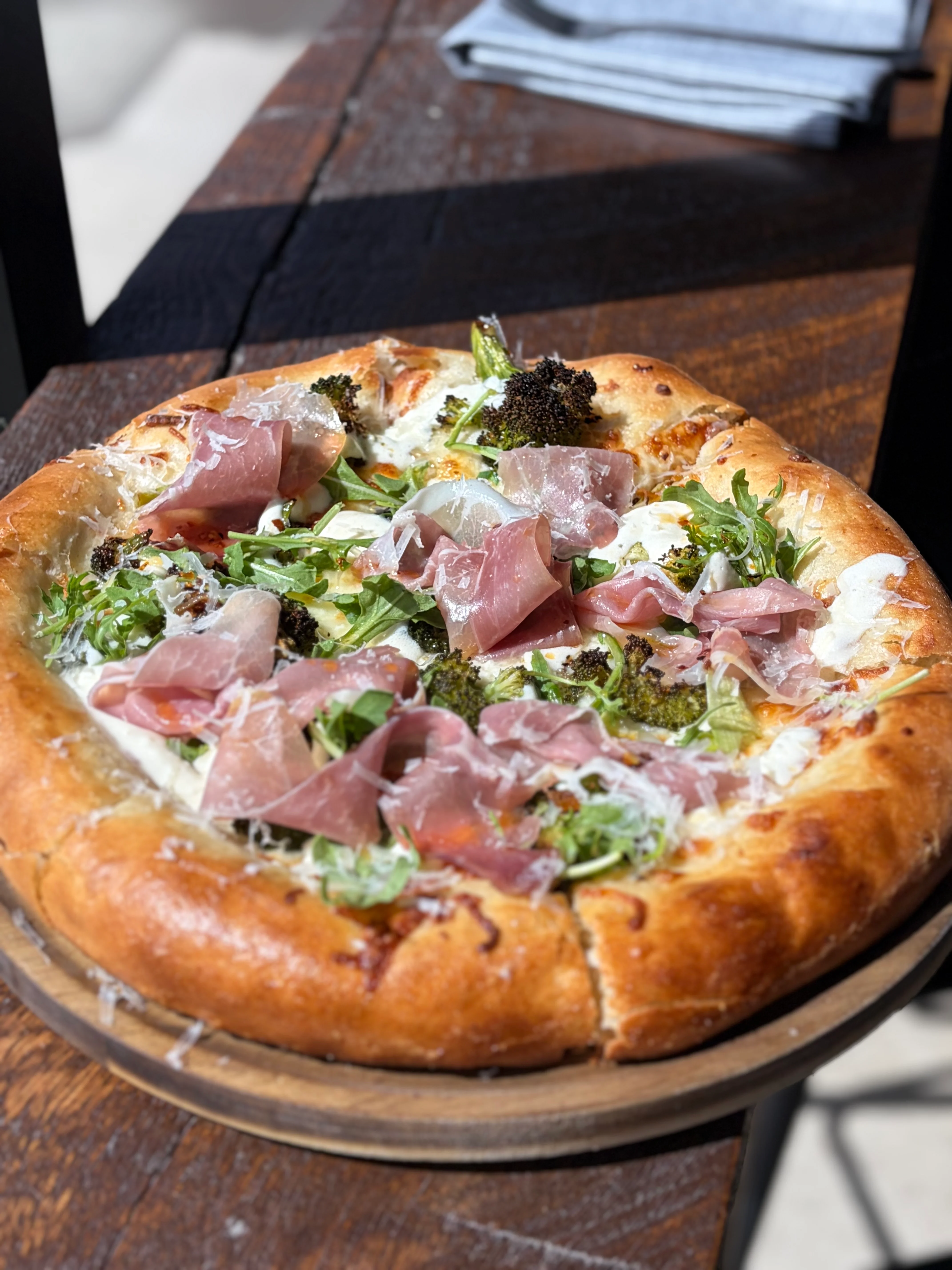 Delicious pizza with fresh toppings served in a cozy bakery setting.
