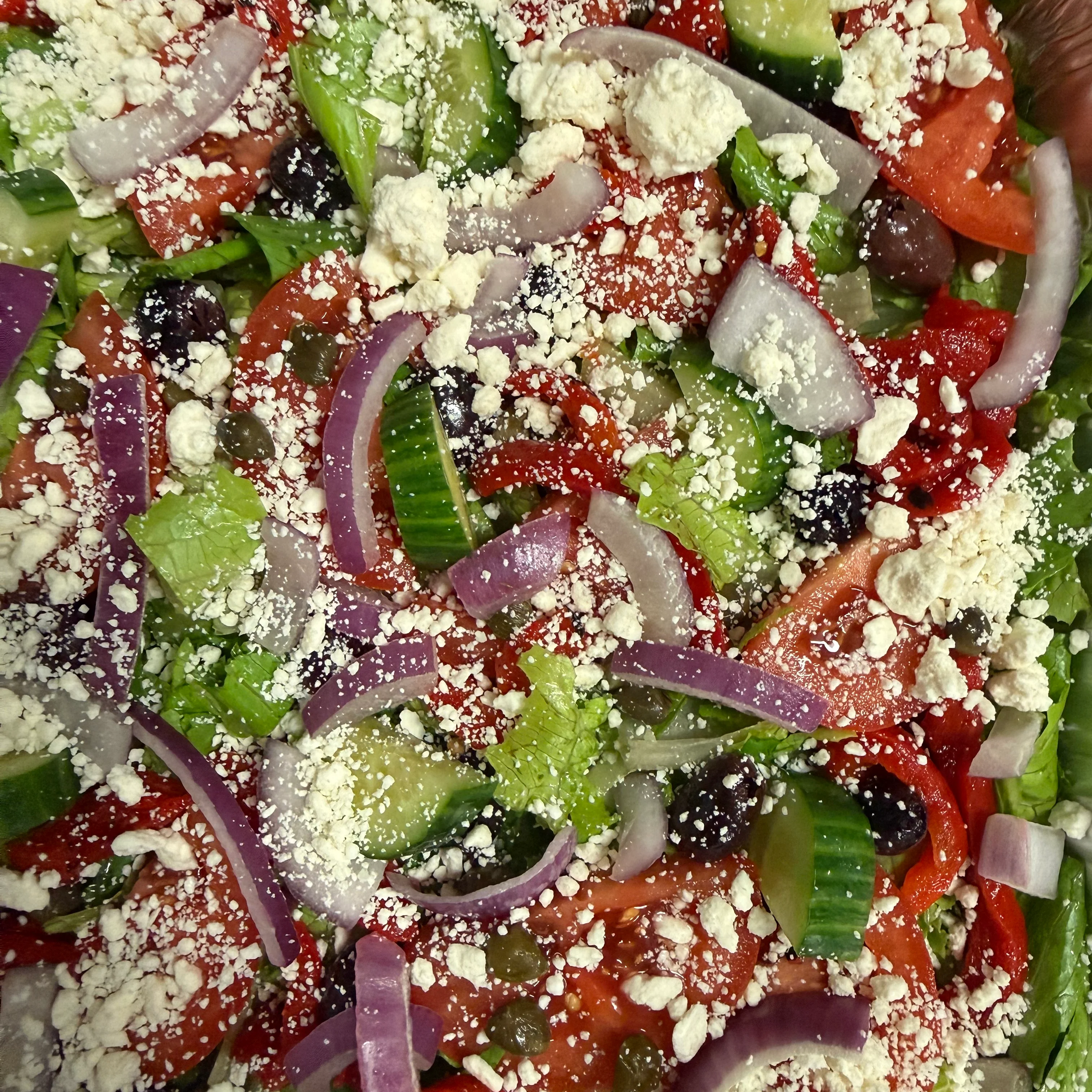 Mediterranean Greek salad topped with feta cheese