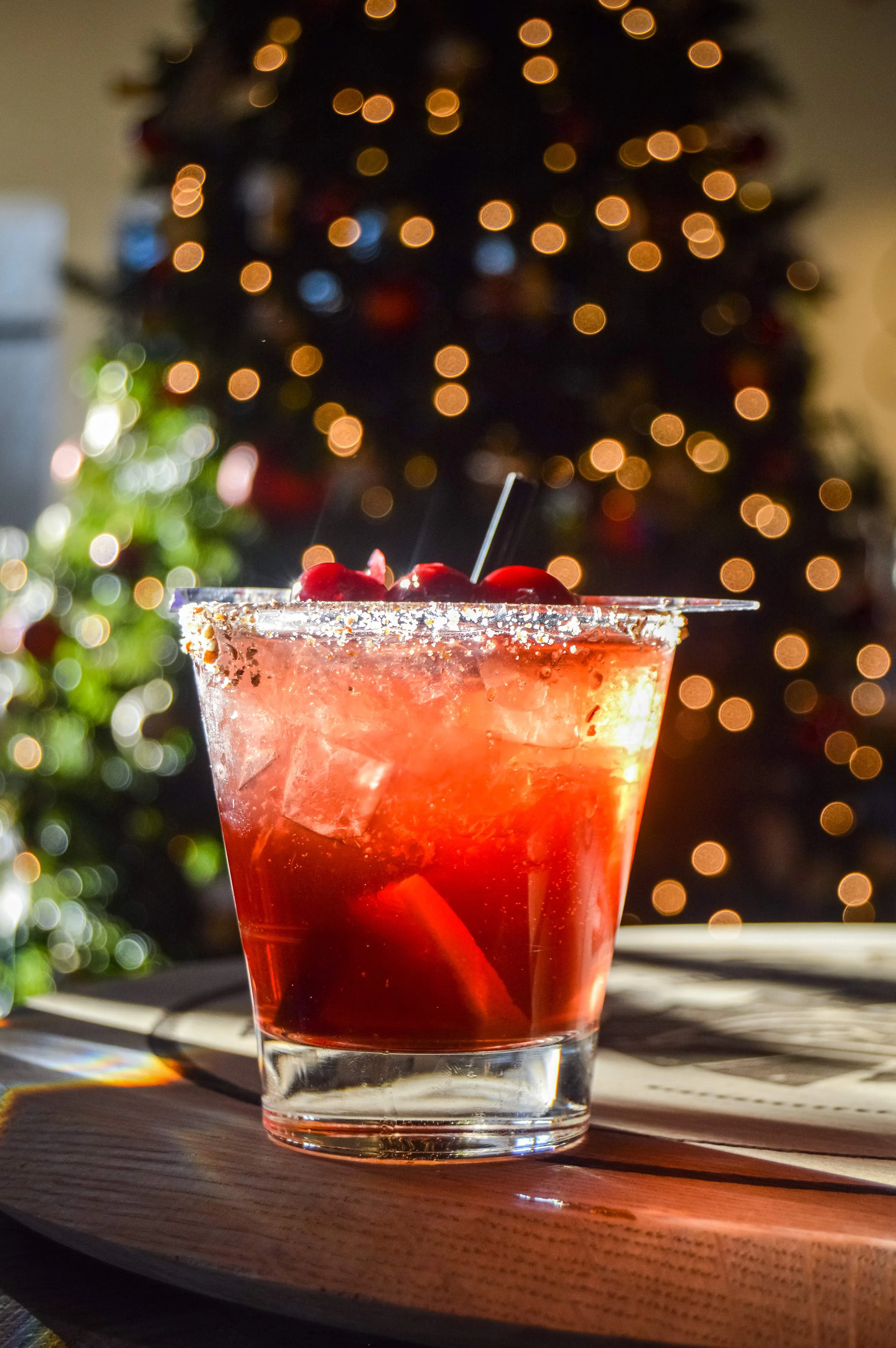 Nutcracker Old Fashioned on top of a barrel with Christmas lights behind it