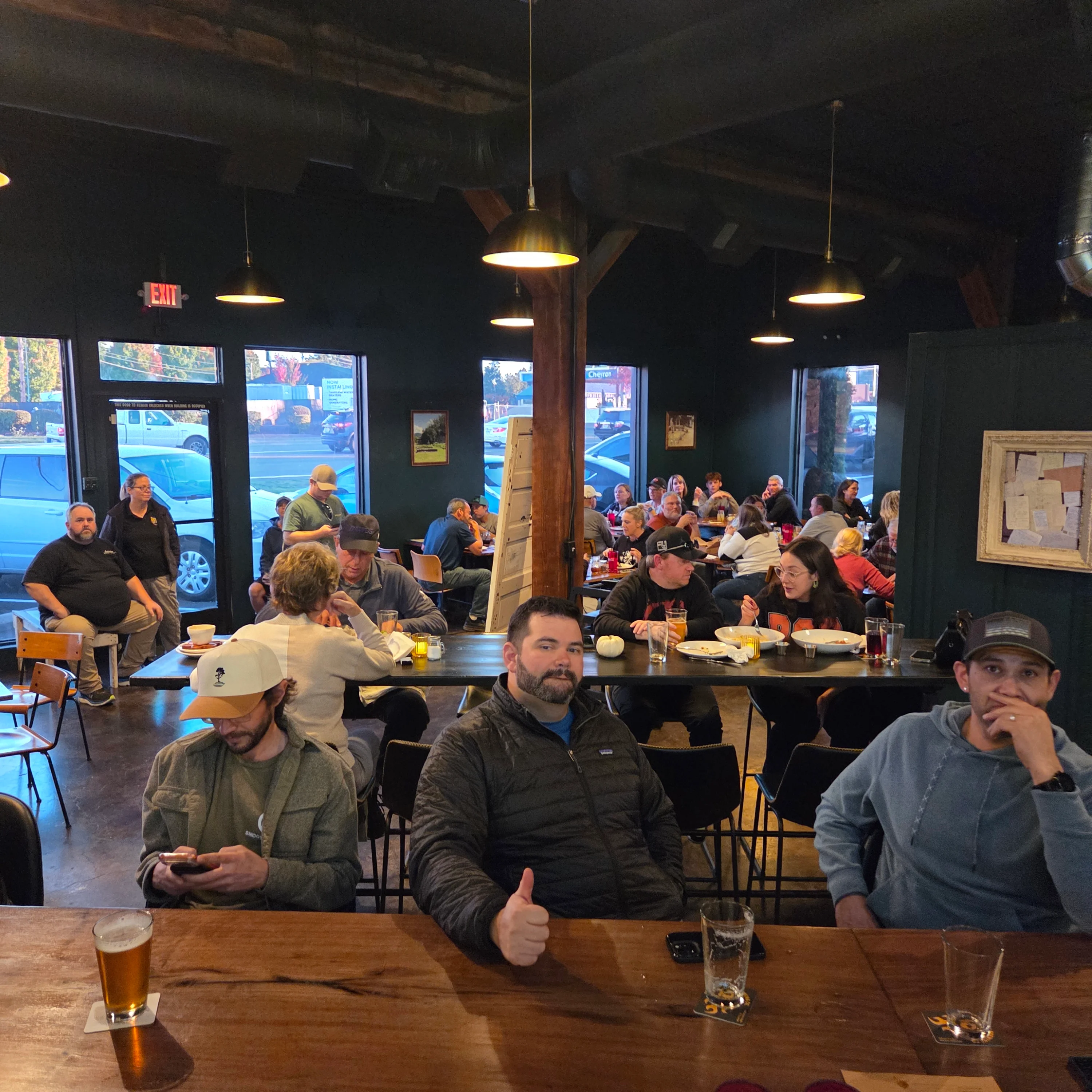 Busy restaurant interior with patrons enjoying meals and drinks