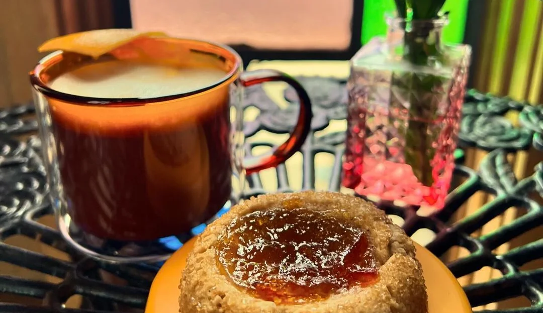 Artisan coffee with a sweet pastry on a decorative table