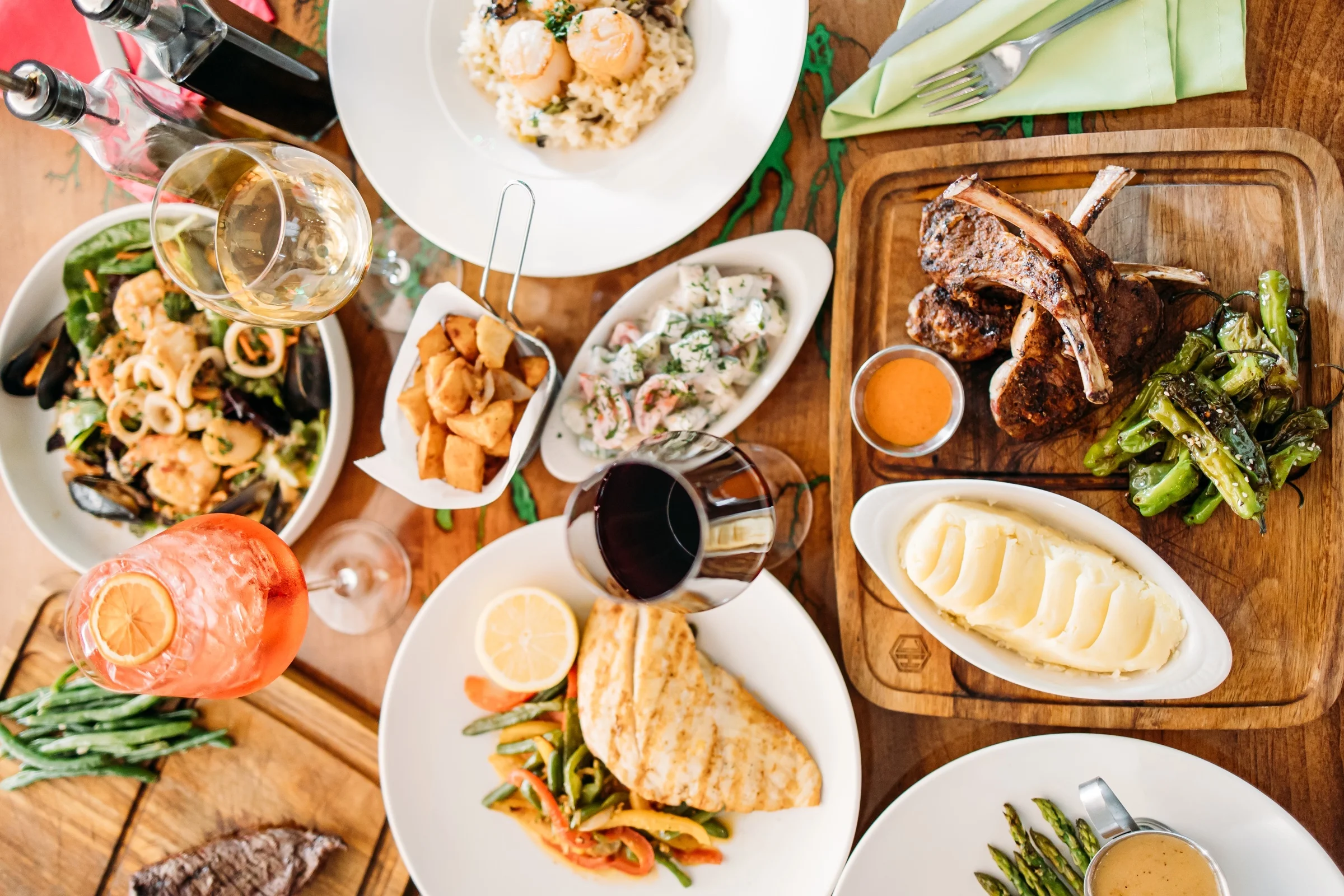 Assorted seafood and grilled meats in a vibrant dining setting