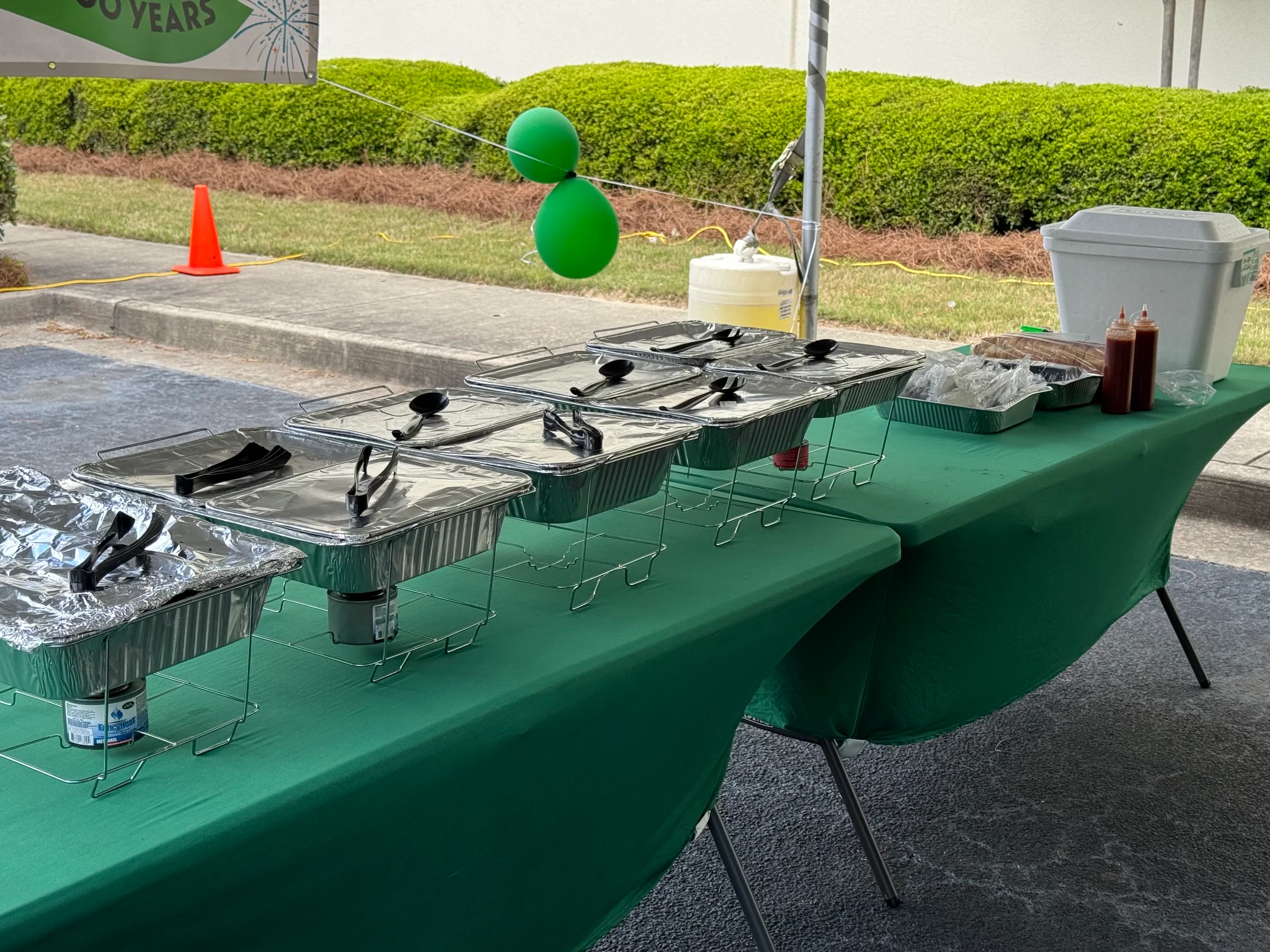 Catering setup with chafing dishes under a tent