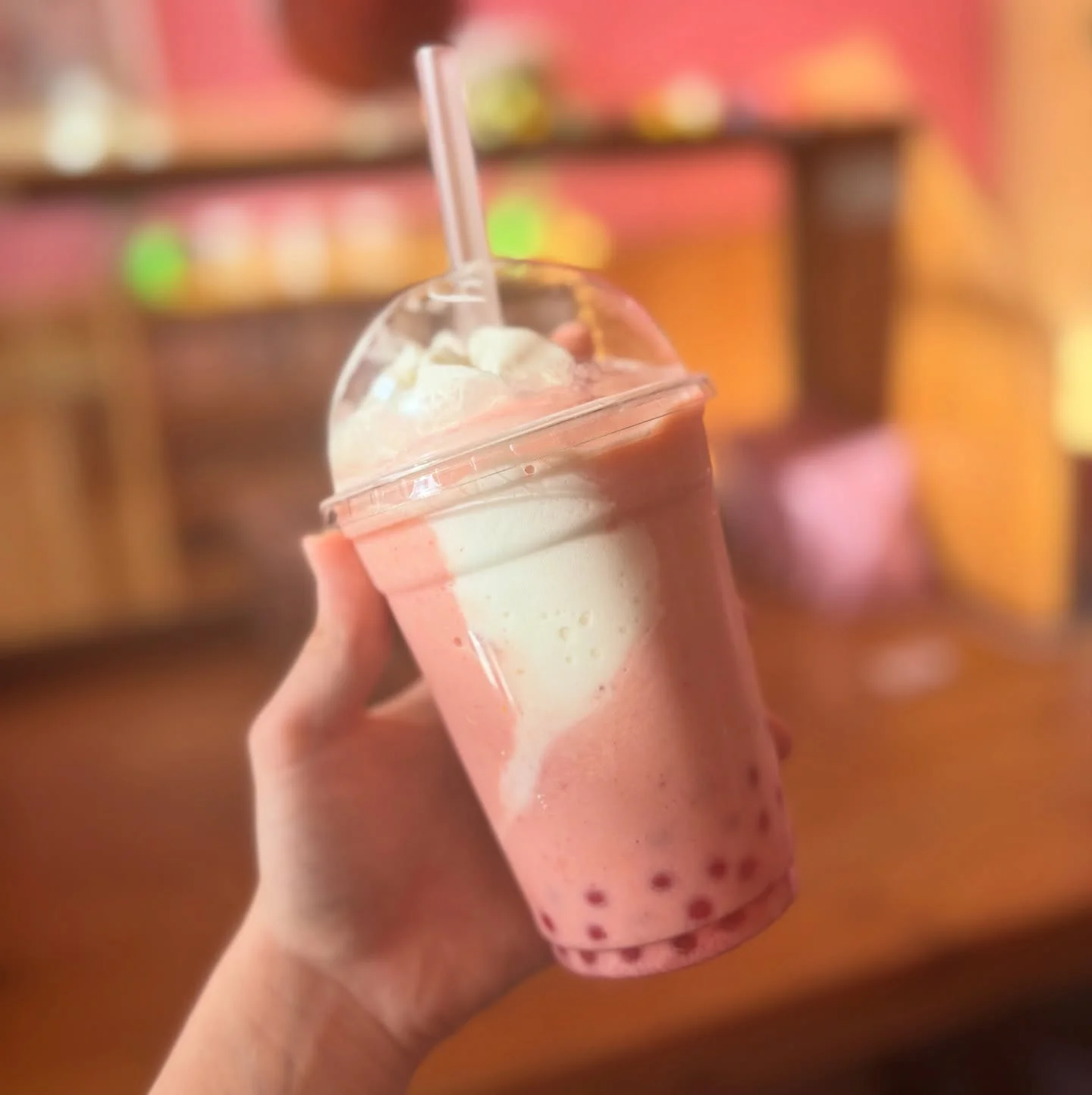 Refreshing strawberry bubble tea with whipped cream