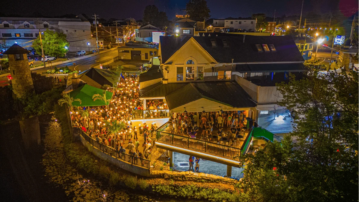 Vibrant nightlife scene with people enjoying drinks and music.