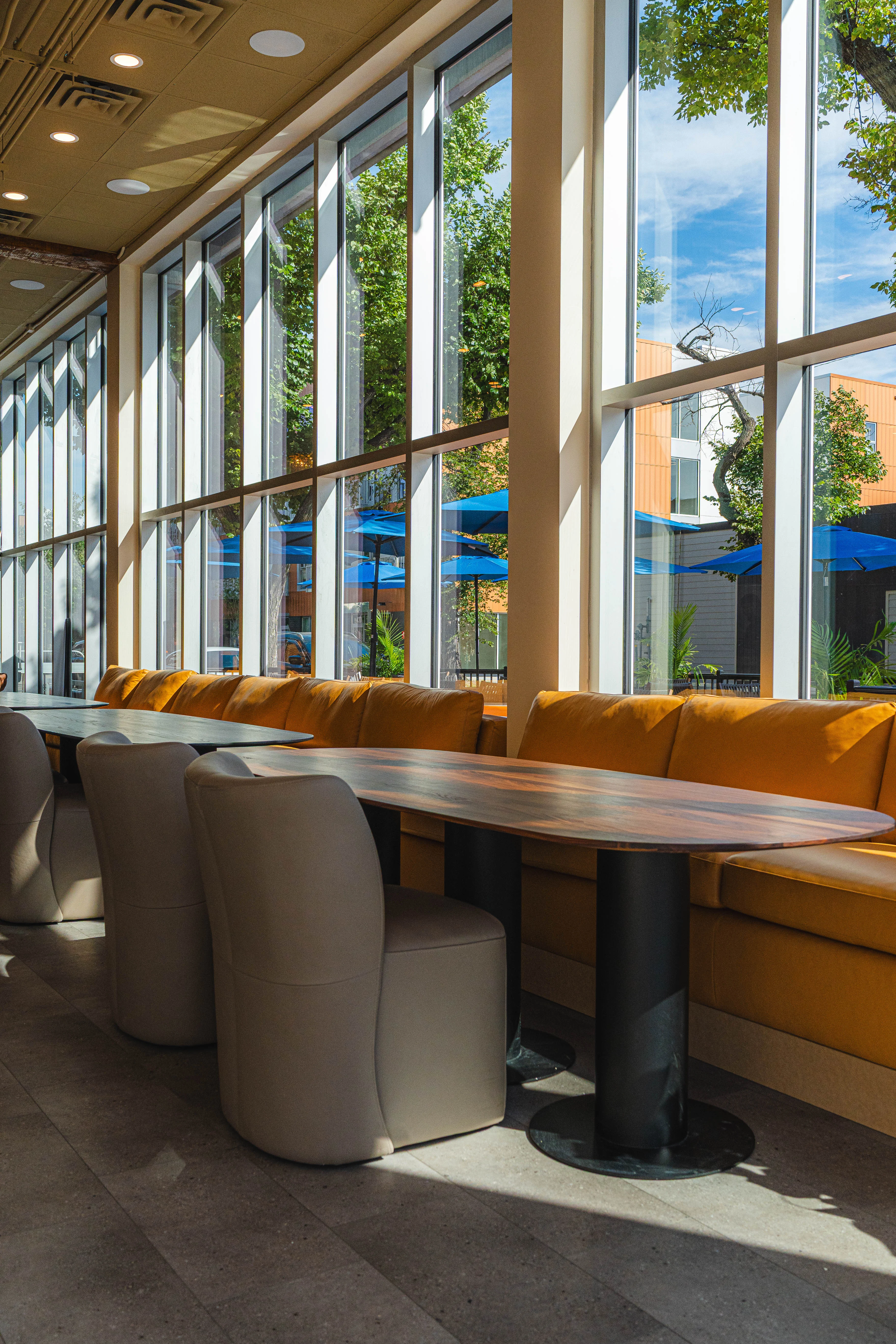 Bright restaurant interior with large windows and cozy seating