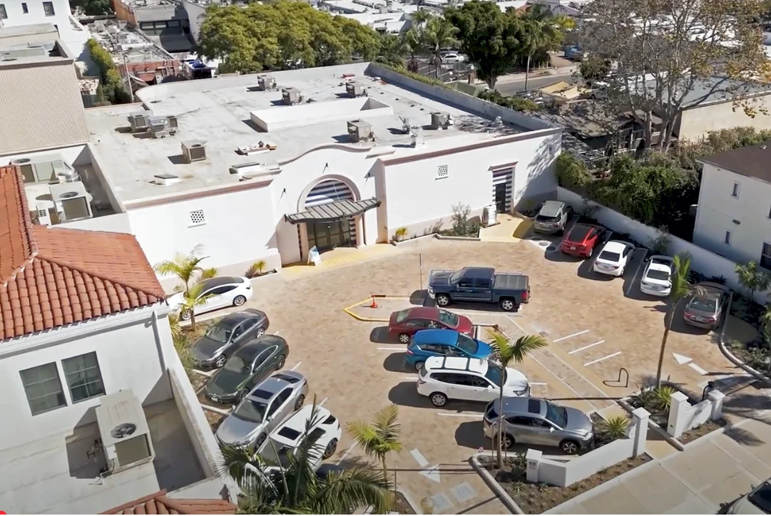Aerial view of a restaurant parking lot with various cars