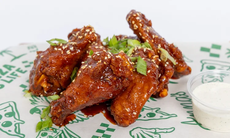 Crispy chicken sandwich with spicy sauce and garnishes