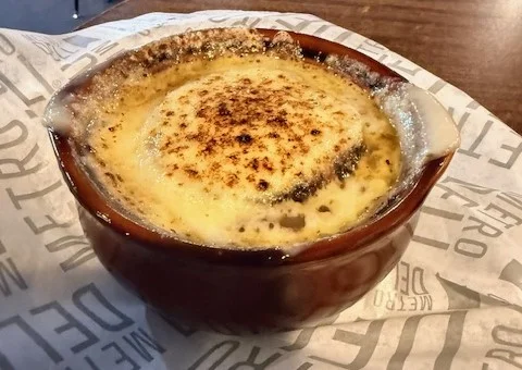 French onion soup with melted cheese in a rustic bowl