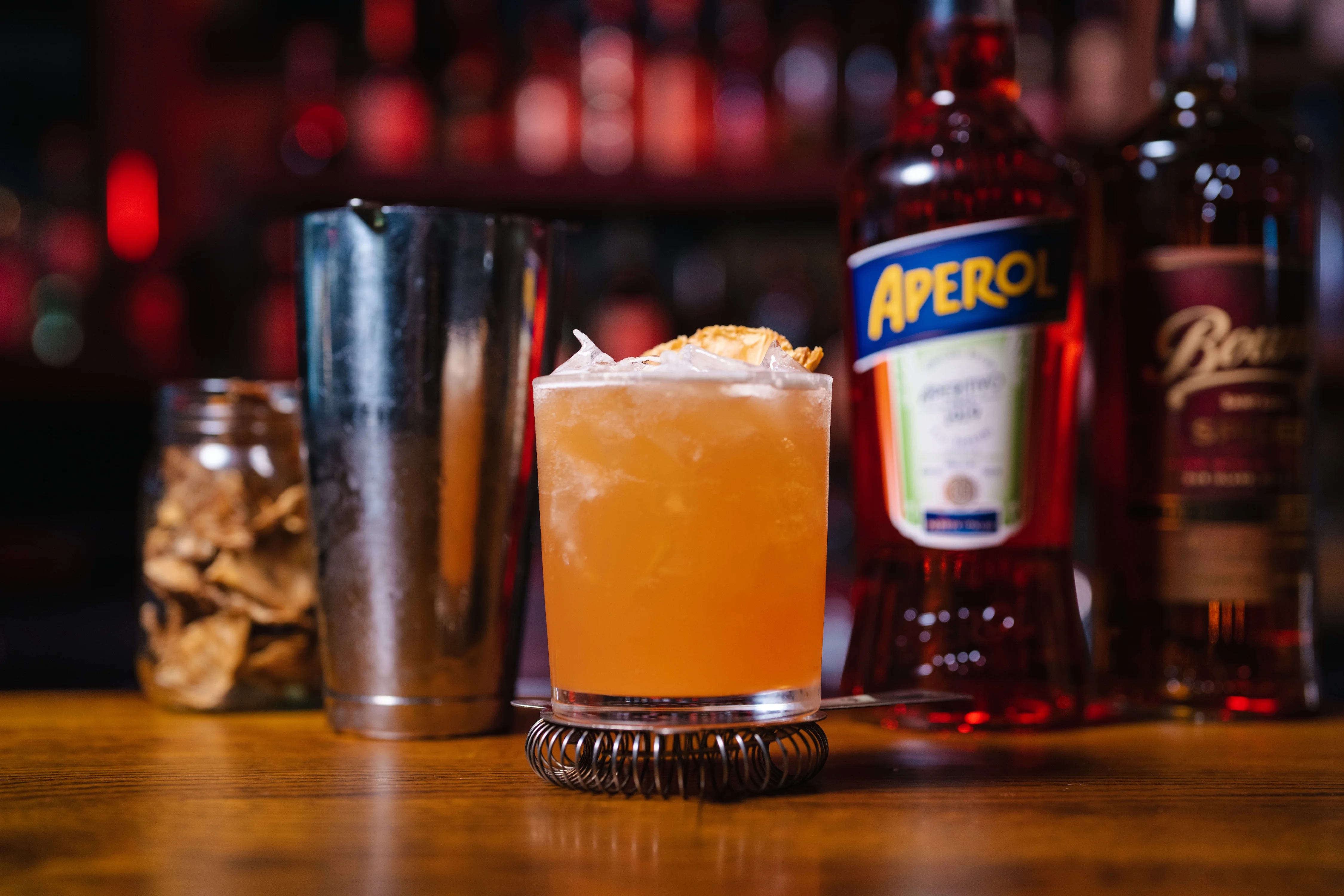 Craft cocktail featuring Aperol and ice in a stylish glass
