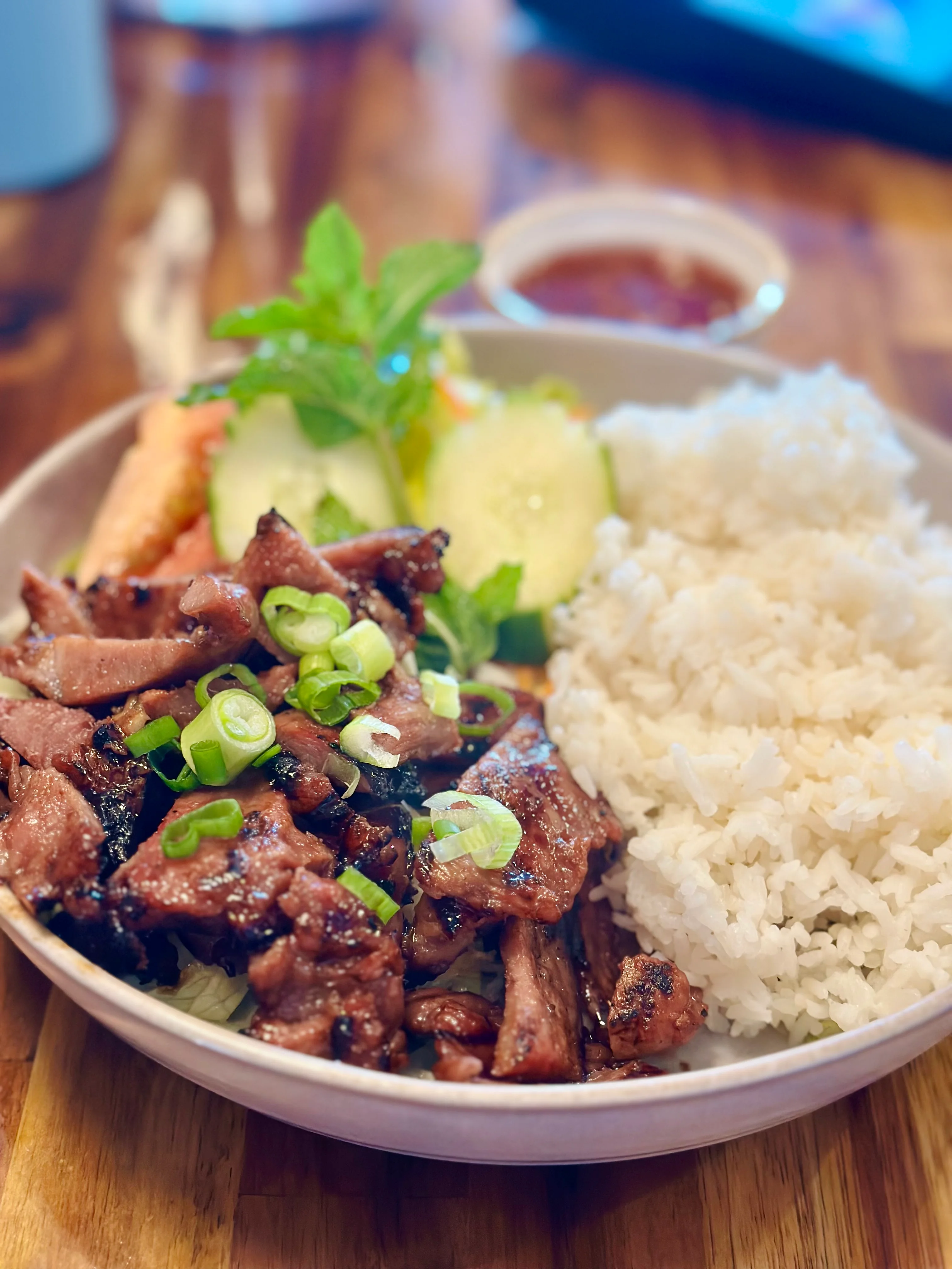 Vietnamese grilled pork rice bowl with fresh herbs