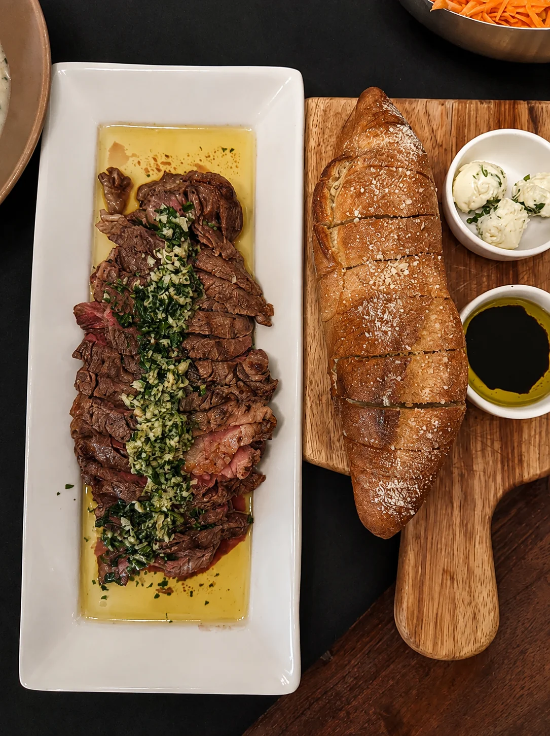 Grilled Argentine steak with chimichurri sauce and crusty bread