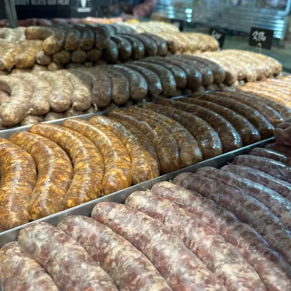 Variety of artisanal sausages displayed in a butcher shop